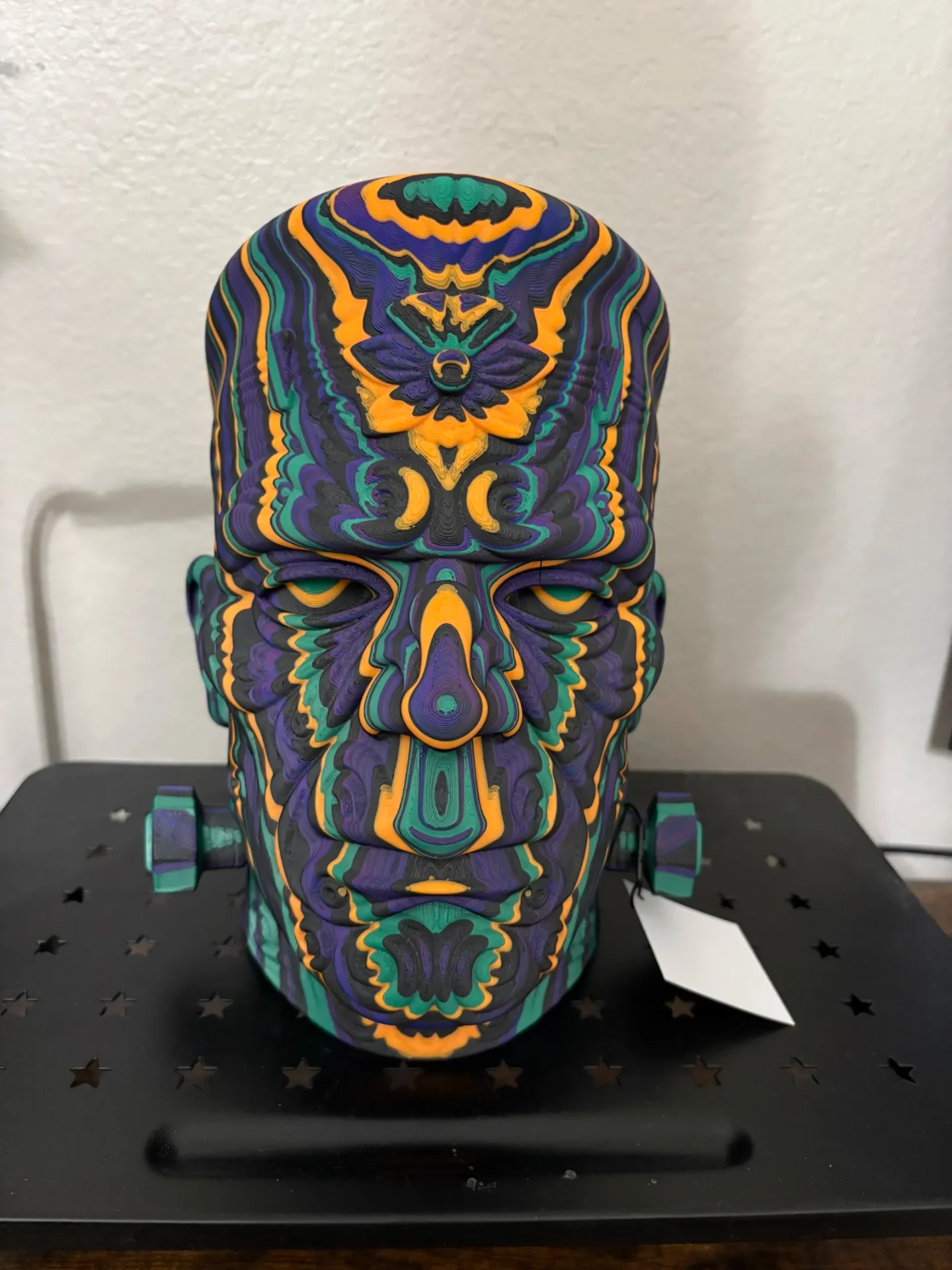 Face mask printed in swirling purple, teal, and orange filament